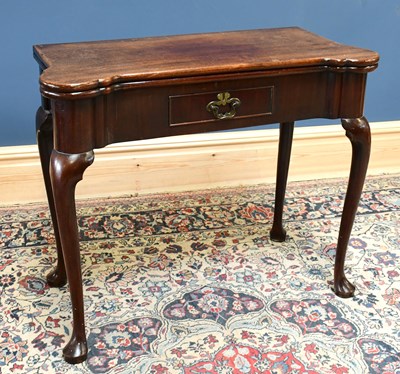 Lot 1538 - A George II mahogany card table, the shaped...