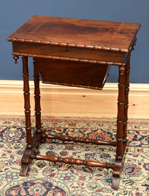 Lot 1568 - A Victorian mahogany sewing table with sliding...