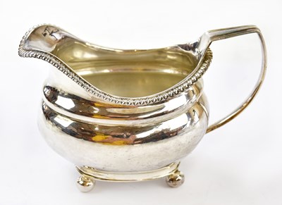 Lot 1063 - A George III hallmarked silver cream jug with...