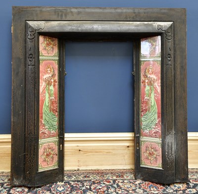 Lot 1518 - A cast iron fireplace inset with Art Nouveau...