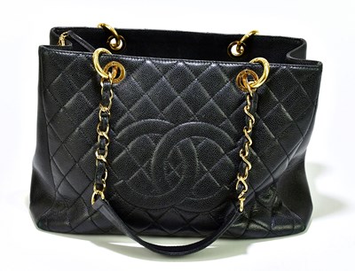 Lot 658 - CHANEL; a black Caviar leather quilted grand...