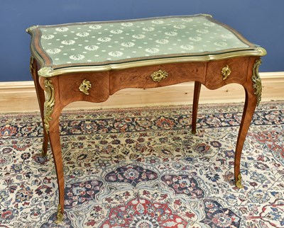 Lot 1532 - A French Louis XV style walnut desk and brass...