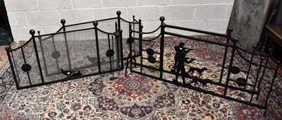 Lot 1548 - Two pairs of decorative hunting themed wrought iron fire guards