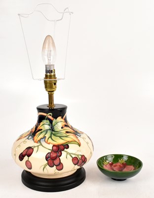 Lot 1317 - MOORCROFT; a lamp decorated with fruit and...