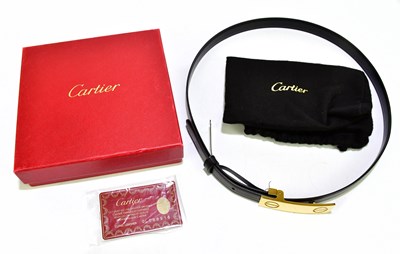 Lot 653 - CARTIER; a boxed black and brown reversible...