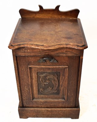 Lot 1493 - An Edwardian oak coal purdonium with carved...