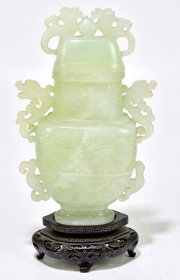 Lot 1191 - A Chinese carved green hardstone vase with...