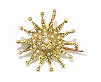 Lot 1447 - A small yellow metal seed pearl set star...