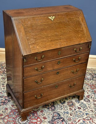 Lot 1658 - A Georgian oak bureau, the fall front...