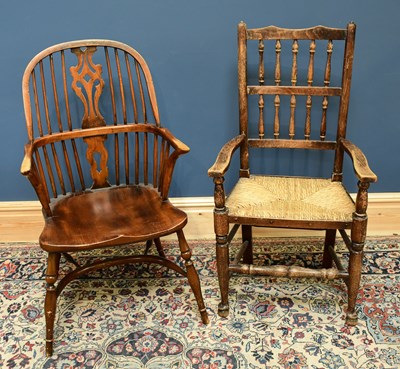 Lot 1676 - A reproduction Windsor elbow chair with...