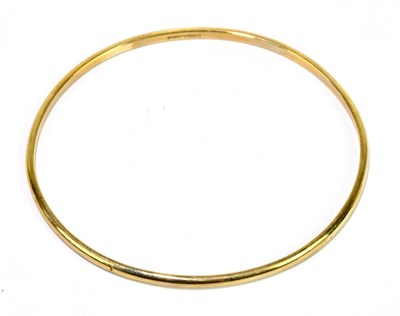 Lot 1275 - A 9ct yellow gold oval fixed bangle, internal...