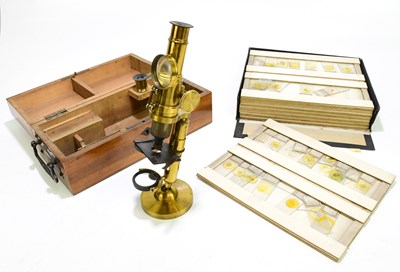 Lot 1128 - A cased student's microscope together with a...