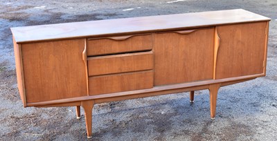 Lot 1703 - A mid-century teak sideboard, with three...
