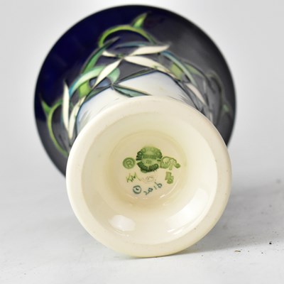 Lot 246 - MOORCROFT; a trumpet-form vase decorated with...
