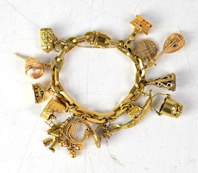 Lot 920 - A yellow metal charm bracelet stamped '750',...
