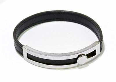Lot 576 - HERMÈS; a black leather and silver tone metal...