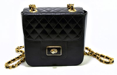 Lot 702 - A black leather and quilted leather square box...