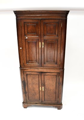 Lot 98 - A late George III oak freestanding corner...