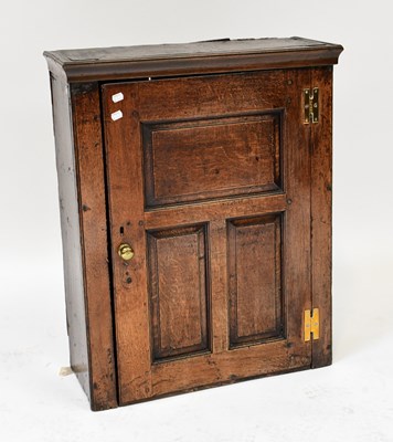 Lot 30 - A George III oak hanging cabinet with three...