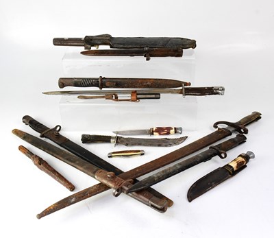 Lot 413 - A collection of bayonets and knives, the...
