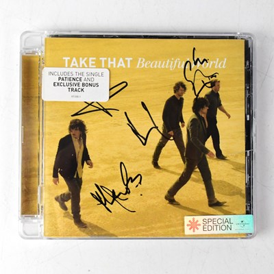 Lot 559 - TAKE THAT; a 'Beautiful World' CD bearing the...