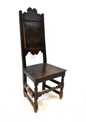 Lot 104 - An early 18th century oak back stool with...
