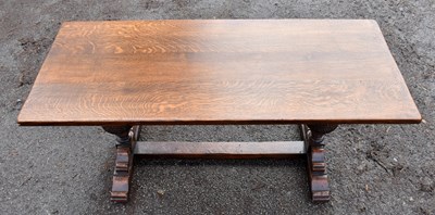 Lot 1734 - An oak rectangular coffee table on carved...