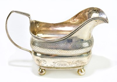 Lot 1066 - A George III hallmarked silver cream jug of...