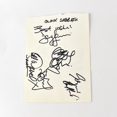 Lot 194 - BLACK SABBATH; a torn page from an autograph...
