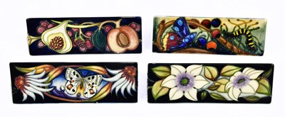 Lot 1774 - MOORCROFT; four advertising triangular shaped...