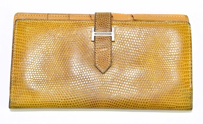 Lot 651 - HERMÈS; a vintage gold lizard skin purse, with...