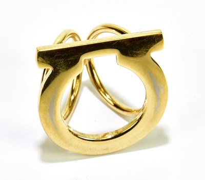 Lot 630 - SALVATORE FERRAGAMO; a Gancini gold tone scarf...