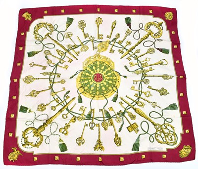 Lot 623 - HERMÈS; a red bordered 100% silk twill scarf...