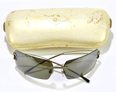 Lot 644 - CHANEL; a pair of vintage sunglasses with gold...