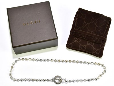 Lot 591 - GUCCI; a hallmarked silver bubble chain with T-...