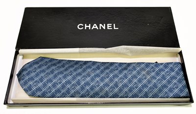 Lot 645 - CHANEL; a 100% silk blue and light blue tie...
