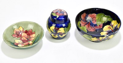 Lot 1641 - MOORCROFT; a Freesia pattern bowl, together...