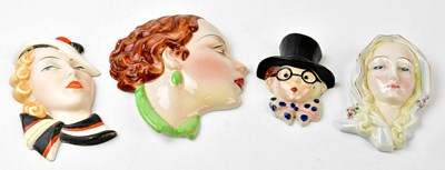 Lot 1702 - COPE & CO; two Art Deco ceramic wall masks, to...