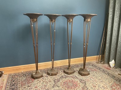 Lot 1195 - Four bronze effect uplights, the dished top...