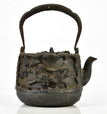 Lot 1202 - A Japanese cast iron tea pot with floral...
