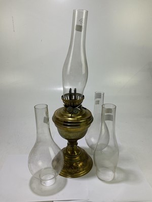 Lot 1209 - A Victorian brass oil lamp with repoussé...
