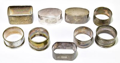 Lot 1130 - A collection of nine hallmarked silver napkin...