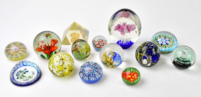Lot 1792 - A group of fourteen glass paperweights, to...