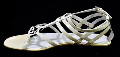 Lot 787 - GUCCI; a pair of unused with tags white...