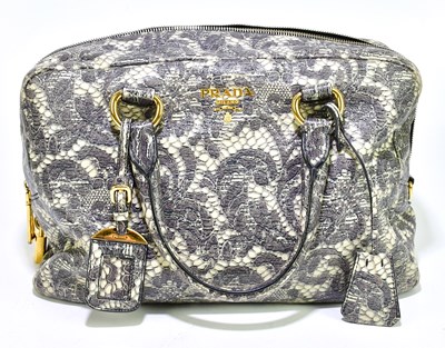 Lot 668 - PRADA; a Cervo Lux lace print bowler bag made...