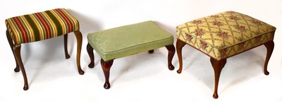 Lot 1731 - Three decorative footstools, each on cabriole...