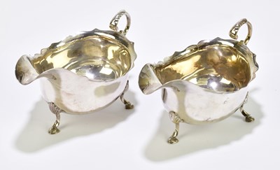 Lot 1114 - A pair of hallmarked silver sauce boats with...