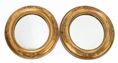 Lot 1472 - A pair of gilt wood oval wall mirrors with...