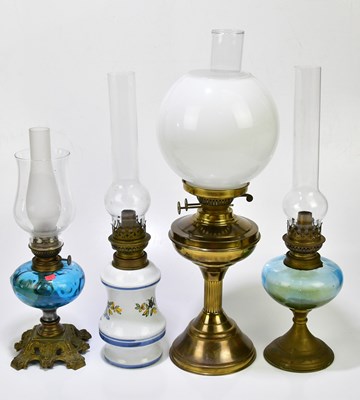 Lot 1201 - An early 20th century oil lamp with blue glass...