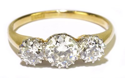 Lot 15 - An 18ct yellow gold and diamond three stone...